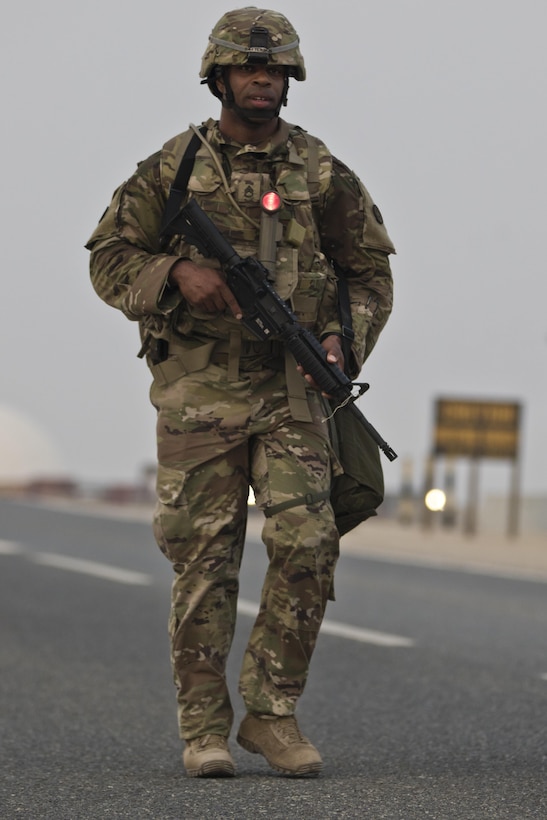Staff Sgt. Andre Patterson, with the 316th Sustainment Command (Expeditionary), pushes himself towards the finish line for the ten-mile ruck march during the 1st Sustainment Command (Theater) Best Warrior Competition at Camp Arifjan, Kuwait, April 15, 2017. (U.S. Army Photo by Staff Sgt. Dalton Smith)