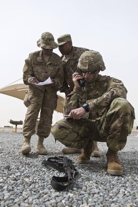 Sgt. Brett Jones, with the 300th Sustainment Brigade, calls in a Spot Report during the 1st Sustainment Command (Theater) Best Warrior Competition at Camp Arifjan, Kuwait, April 15, 2017. (U.S. Army Photo by Staff Sgt. Dalton Smith)