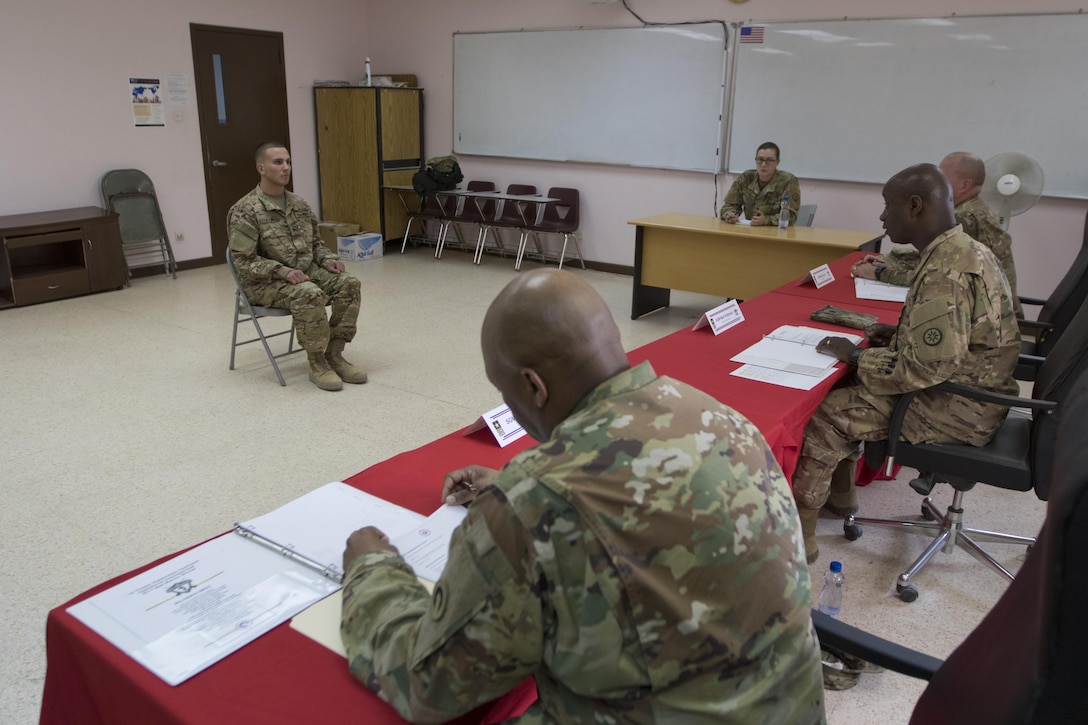 Spc. David Fair, with the 485th Military Police Company, answers questions during 1st Sustainment Command (Theater) Best Warrior Competition appearance board at Camp Arifjan, Kuwait, April 15, 2017. (U.S. Army Photo by Staff Sgt. Dalton Smith)