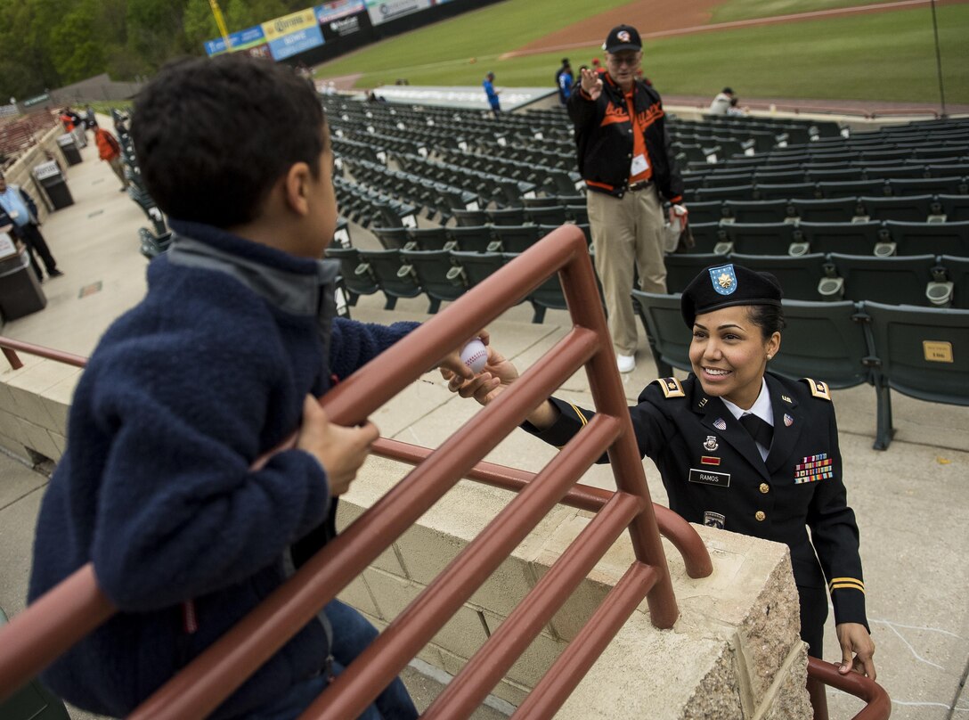 Maj. Stephanie Ramos, a U.S. Army Reserve public affairs officer from the 200th Military Police Command, headquartered at Fort Meade, Md., hands a baseball to her son during a celebration event for the Army Reserve's 109th birthday with the Bowie Baysox baseball club at Prince George's Stadium, April 19, 2017. The 200th MP Cmd. is located less than 20 miles from the stadium, and sought this opportunity to engage with the local community. The U.S. Army Reserve's official birthday is on April 23. (U.S. Army Reserve photo by Master Sgt. Michel Sauret)