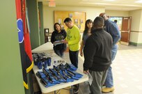 Melani Tescher, (center) chief, Environmental Division, Directorate of Public Works for the 88th Regional Support Command, talks with other members of the 88th RSC staff about Earth Day events across the 19-state region.