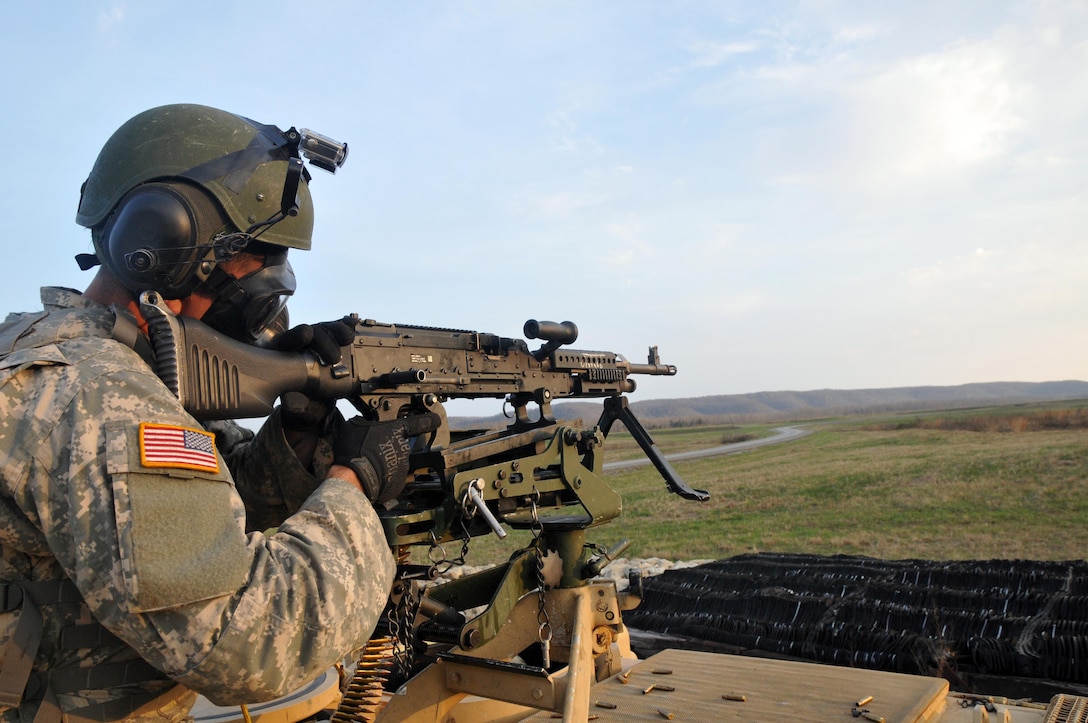 U.S. Army Reserve Spc. Jonathan O'Bryant, 979th Mobility Augmentation Company, 478th Engineer Battalion, 926th Engineer Brigade, 412th Theater Engineer Command, based in Lexington, Ky., engages a target while wearing his field protective mask during a live-fire qualification at Wilcox Range on Fort Knox, Ky., March 29, 2017. This is the first time that this company has fired its M2s and M240B machine guns from M113 Armored Personnel Carriers. (U.S. Army Reserve Photo by Sgt. 1st Class Clinton Wood)