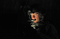 U.S. Army Reserve Spc. Dalton Phillips , 979th Mobility Augmentation Company, 478th Engineer Battalion, 926th Engineer Brigade, 412th Theater Engineer Command, based in Lexington, Ky., checks his cellular phone while he and his gun crew wait for their Gunnery Table 4 night live-fire qualifcation run in their M1113 Armored Personnel Carrier (APC) at Wilcox Range on Fort Knox, Ky., March 29, 2017. This is the first time that this company has fired its M2s and M240B Machine Guns from APCs. (U.S. Army Reserve Photo by Sgt. 1st Class Clinton Wood)