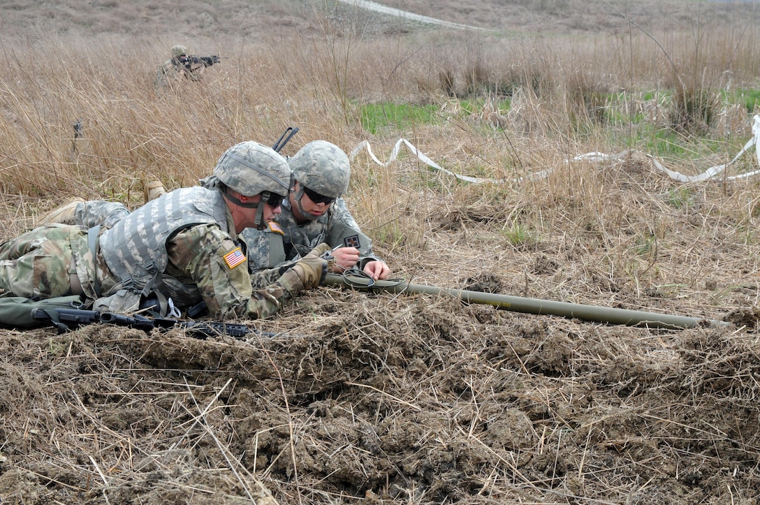 U.S. Army Reserve Sgt. Daniel Patrick, left, and Spc. Aaron Elliot, both with the 979th Mobility Augmentation Company, 478th Engineer Battalion, 926th Engineer Brigade, 412th Theater Engineer Command, based in Lexington, Ky., emplace a Bangalore torpedo during the company's training at Wilcox Range on Fort Knox, Ky., March 30, 2017. This was part of Engineer Qualification Table (EQT) VIII. The company went on to be certified in EQT X11 becoming the first U.S. Army Reserve unit to accomplish this feat. (U.S. Army Reserve Photo by Sgt. 1st Class Clinton Wood)