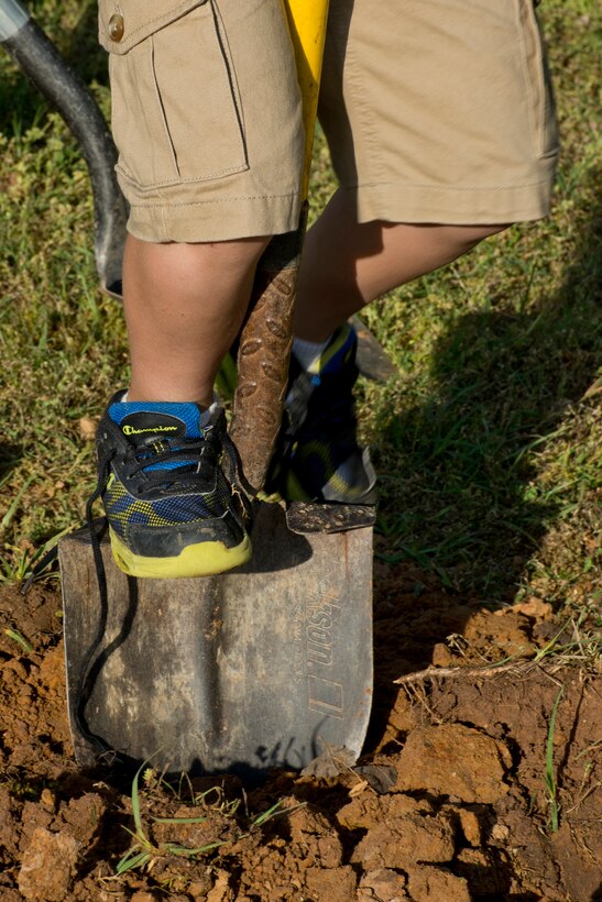 A Cub Scout belonging to Pack 170, located at Little Rock Air Force Base, Ark., helps plant fruit trees on base April 19, 2017.  The local Cub Scout Pack currently has 17 members and planted two fruit trees that attract pollinators such as bees, wasps, humming birds and butterflies in honor of Earth Day 2017. (U.S. Air Force photo by Master Sgt. Jeff Walston/Released)