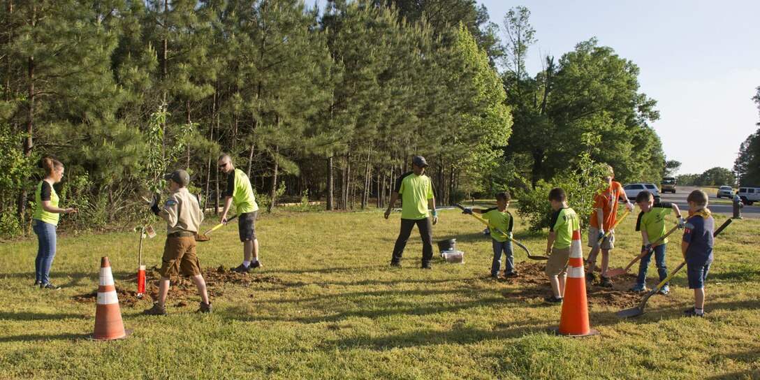 Members of Cub Scout Pack 170, plant two fruit trees April 19, 2017, to attract pollinators such as bees, wasps, humming birds and butterflies to Little Rock Air Force Base, Ark.  Pack 170 currently has 17 members and is located on the base. The trees were planted the in honor of the “Rusty Patch Bumble Bee,” that was added to the federal Endangered Species List early this year. (U.S. Air Force photo by Master Sgt. Jeff Walston/Released)