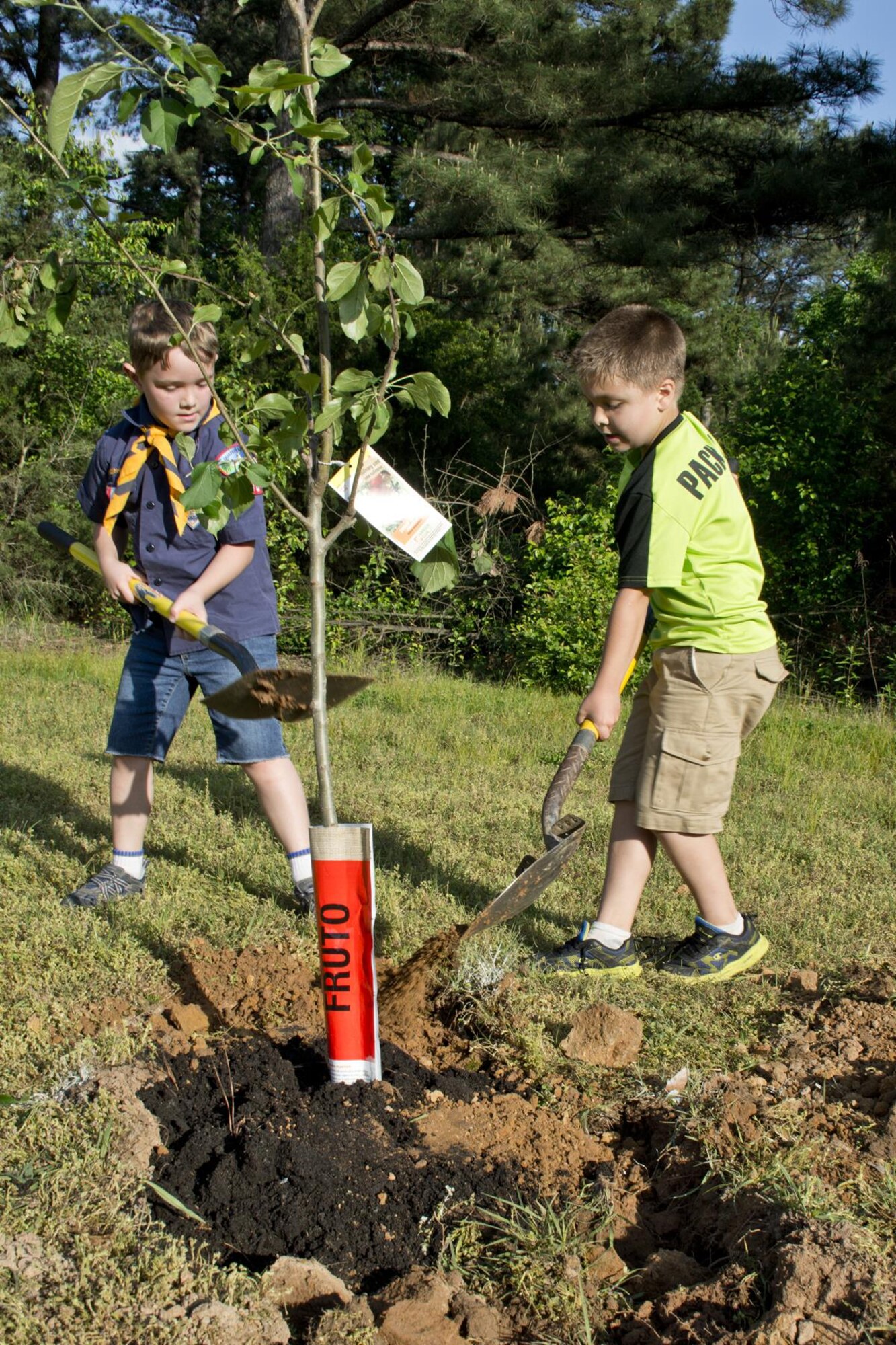 (Left to Right) Wolf Cub Scouts Kaemon Turan and Gauge Colburn help plant fruit trees April 19, 2017, at Little Rock Air Force Base, Ark. Both Kaemon and Gauge are members of Cub Scout Pack 170, which is located on base. The 17 member pack planted two fruit trees in honor of Earth Day to attract pollinators such as bees, wasps, humming birds and butterflies. Kaemon is the son of Air Force Master Sgt. Eric Turan, a loadmaster assigned to the 61st Airlift Squadron, and Gauge is the son of Air Force Tech Sgt. Zach Colburn, a fireman assigned to the 19th Civil Engineer Squadron. (U.S. Air Force photo by Master Sgt. Jeff Walston/Released)