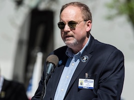 DAYTON, Ohio (04/2017) -- Jeff Thatcher, son of Doolittle Raider, Staff Sgt. David Thatcher, gives remarks at the National Museum of the United States Air Force April 18, 2017. The memorial service, including a wreath laying, honored the 75th anniversary of the Doolittle Tokyo Raid in which 80 volunteers used 16 B-25 bombers to strike the Japanese mainland from the USS Hornet aircraft carrier, turning the tide of World War II. The ceremony included two flyovers of B-25 bombers, one in the missing man formation, and a B-1B bomber flyover, one of which had been rechristened the "Ruptured Duck" in a ceremony the day before. Staff Sgt. Thatcher was a crew member on the original Ruptured Duck, during the Doolittle Raid. (U.S. Air Force photo by Ken LaRock) 