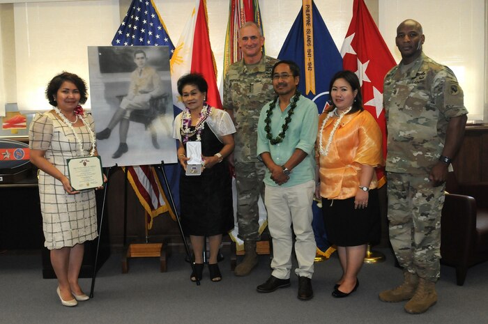 Gen. Robert B. Brown (center), Commanding General, U.S. Army Pacific, and USARPAC Command Sgt. Maj. Bryant Lambert (right), pose for a picture with Elisea Alagon Jamoralin (second from left), whose father Pfc. Adriano Alagon died while serving with the Philippine Scouts during the Japanese occupation of the Philippines. Brown presented Jamoralin with a replacement Purple Heart medal to replace the original that was lost during the turmoil and chaos of post-World War II Philippines. Also present is Philippine Consul General in Honolulu Gina A. Jamoralin, the granddaughter of Pfc. Alagon (left) and other family members. 