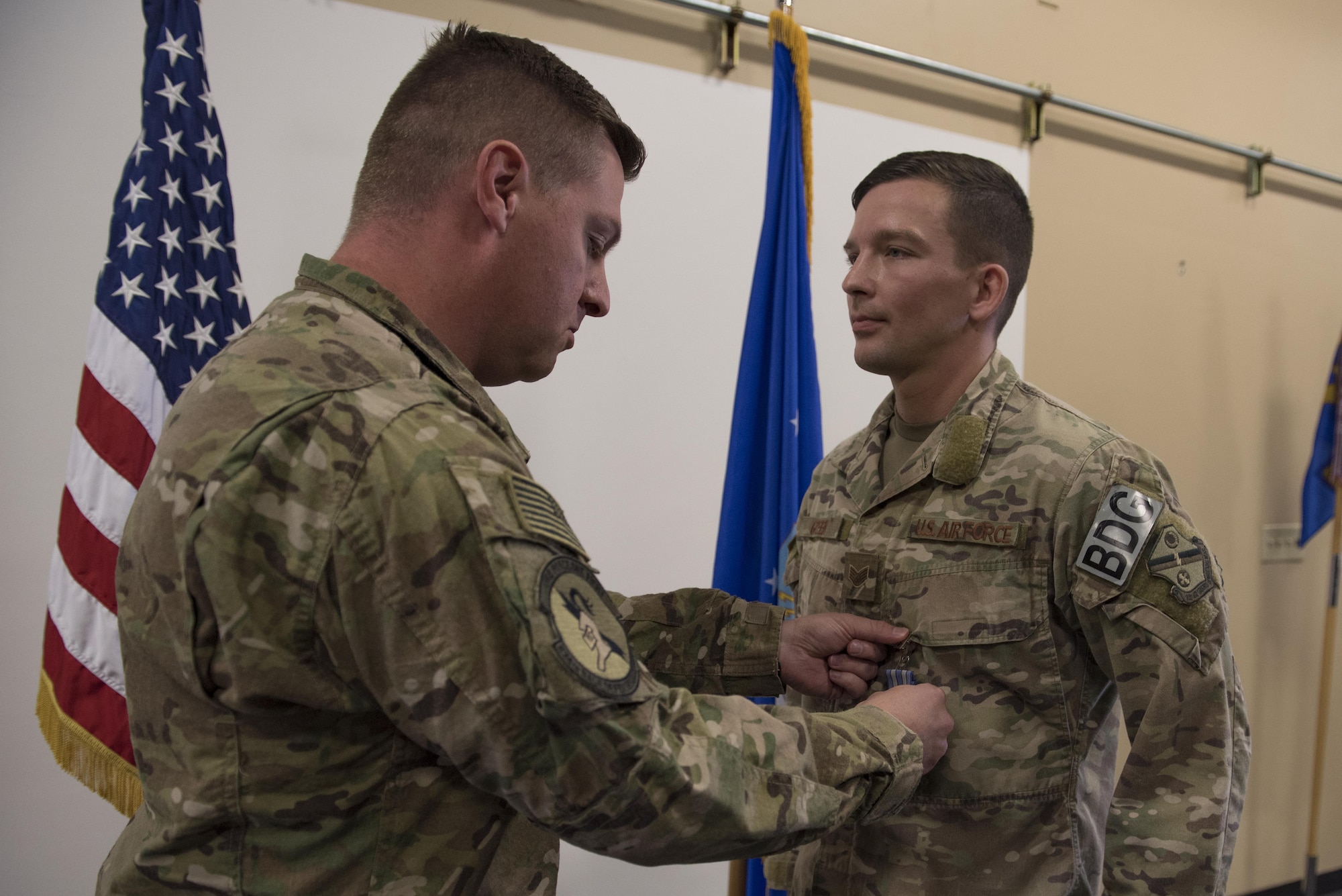 Maj. Michael Warren, 824th Base Defense Squadron commander, pins an achievement medal on Staff Sgt. David Green, 824th BDS fireteam leader, April 10, 2017, at Moody Air Force Base, Ga. Green received the medal for his act of heroism when he helped a trapped victim during an off-base vehicle incident. (U.S. Air Force photo by Airman 1st Class Lauren M. Sprunk)
