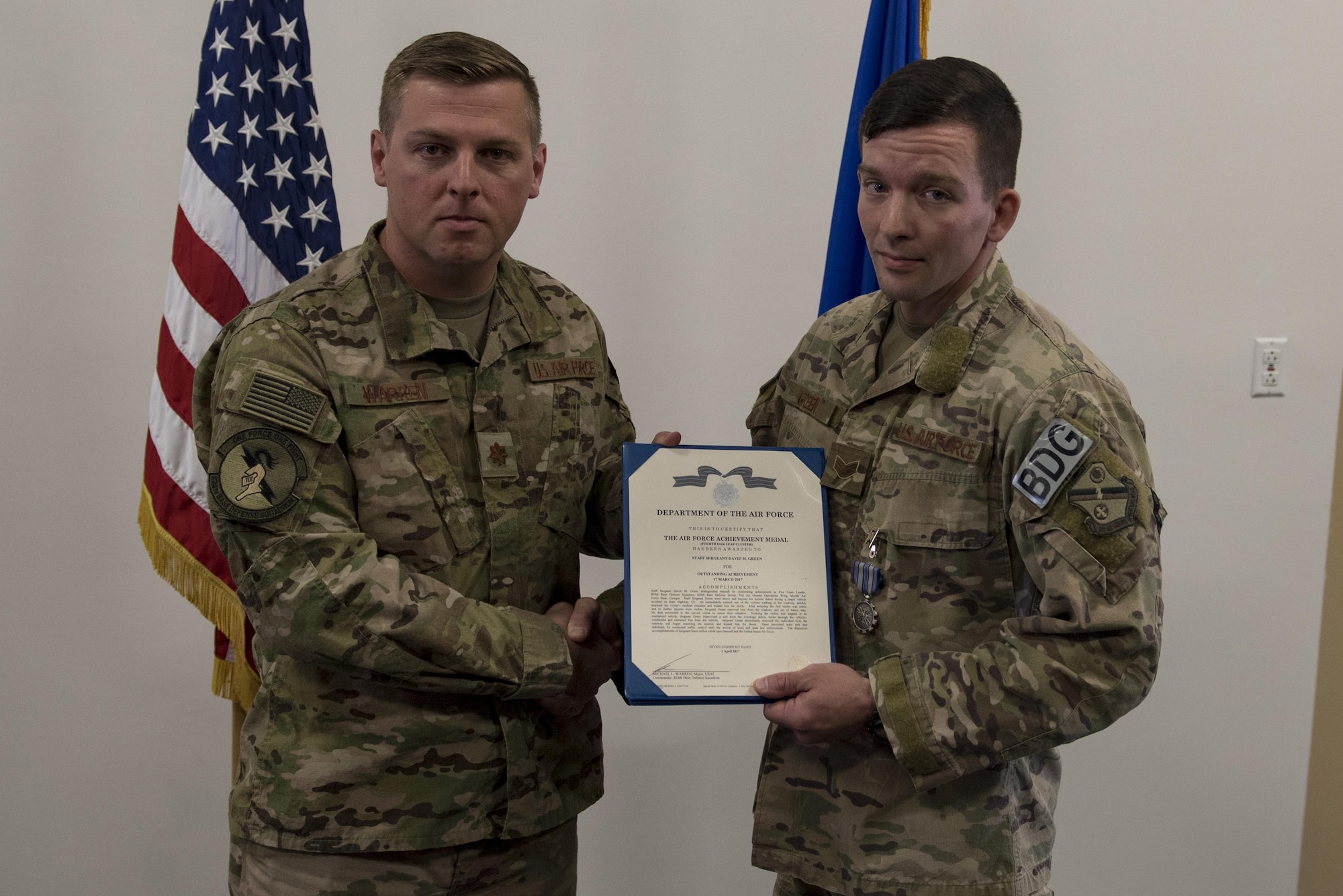 Maj. Michael Warren, 824th Base Defense Squadron commander, awards Staff Sgt. David Green, 824th BDS fireteam leader, with an achievement medal, April 10, 2017, at Moody Air Force Base, Ga. Green received the medal for his act of heroism when he helped a trapped victim during an off-base vehicle incident. (U.S. Air Force photo by Airman 1st Class Lauren M. Sprunk)