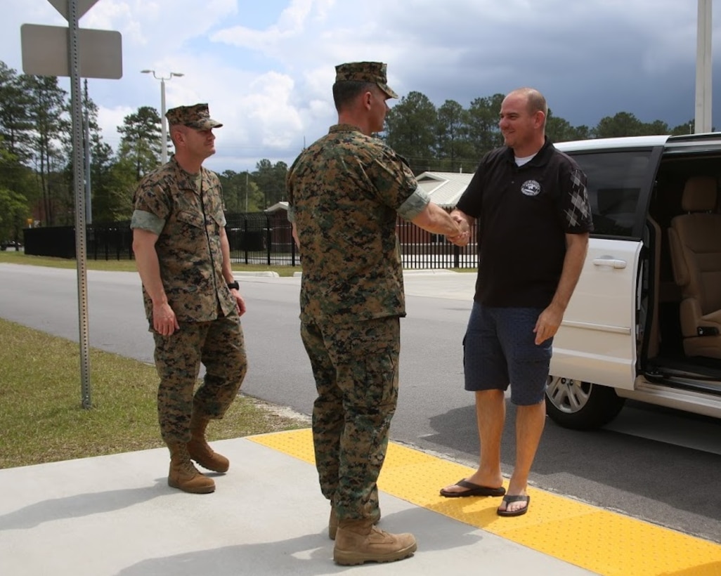 Sgt. Maj. Marinica Ariton, left, and Lt. Col. Jeremy Winters, center, welcome Will Lewis, mayor of Havelock to the Marine Air Support Squadron 1 facilities at Marine Corps Air Station Cherry Point, N.C., April 14, 2017. Lewis was accompanied by former MASS-1 Marine, Mark Carter, during a tour of the MASS-1 facilities. MASS-1, Marine Air Control Group 28, 2nd Marine Aircraft Wing, is responsible for the planning, receiving, coordination and processing of requests for direct or close air support. Winters is the commanding officer of MASS-1 and Ariton is the squadron sergeant major. (U.S. Marine Corps photo by Sgt. N.W. Huertas/Released) 
