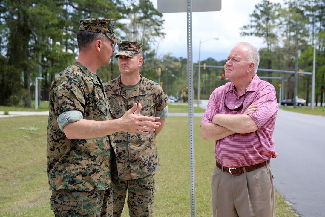 Lt. Col. Jeremy Winters, left, and Sgt. Maj. Marinica Ariton center, welcome Marine Mark Carter to the Marine Air Support Squadron 1 facilities at Marine Corps Air Station Cherry Point, N.C., April 14, 2017. Cartrer was accompanied by Will Lewis, mayor of Havelock during a tour of MASS-1, Marine Air Control Group 28, 2nd Marine Aircraft Wing. Carter is the general manager of Wells Global and was assigned to MASS-1 during his time in the Corps as a sergeant. Winters is the commanding officer of MASS-1 and Ariton is the Squadron sergeant major. (U.S. Marine Corps photo by Sgt. N.W. Huertas/Released) Huertas/Released) 
