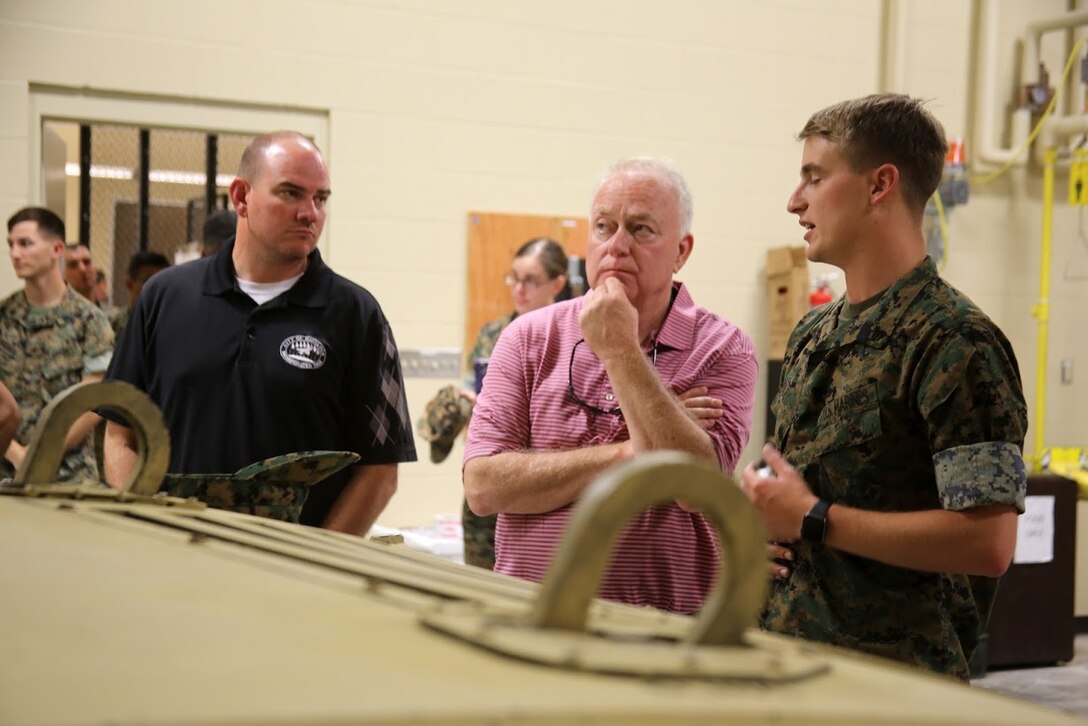 Will Lewis, mayor of Havelock, left, and Marine Mark Carter are briefed by Cpl. Matthew Foley during a tour at Marine Corps Air Station Cherry Point, N.C., April 14, 2017. Carter and Lewis toured the Marine Air Support Squadron 1 facilities and had a first-hand look at the squadron’s mission. MASS-1, Marine Air Control Group 28, 2nd Marine Aircraft Wing, is responsible for the planning, receiving, coordination and processing of requests for direct or close air support. Foley is a communications maintenance noncommissioned officer with the  unit. (U.S. Marine Corps photo by Sgt. N.W. Huertas/Released)