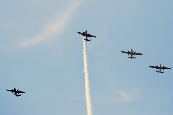 Four U.S. Air Force B-25 bombers fly the "Missing Man" formation over a memorial service honoring the 75th anniversary of the Doolittle Raid. The memorial service, held at the National Museum of the U.S. Air Force April 18, 2017, included two B-25 fly-overs. The first was a typical bomber staggered formation, and included 11 aircraft. The second was the “Missing Man” formation and honored the 79 members of the original Raiders who have passed. The last living Raider, Lt. Col. (Ret.) Richard Cole, was a participant in the memorial ceremony.