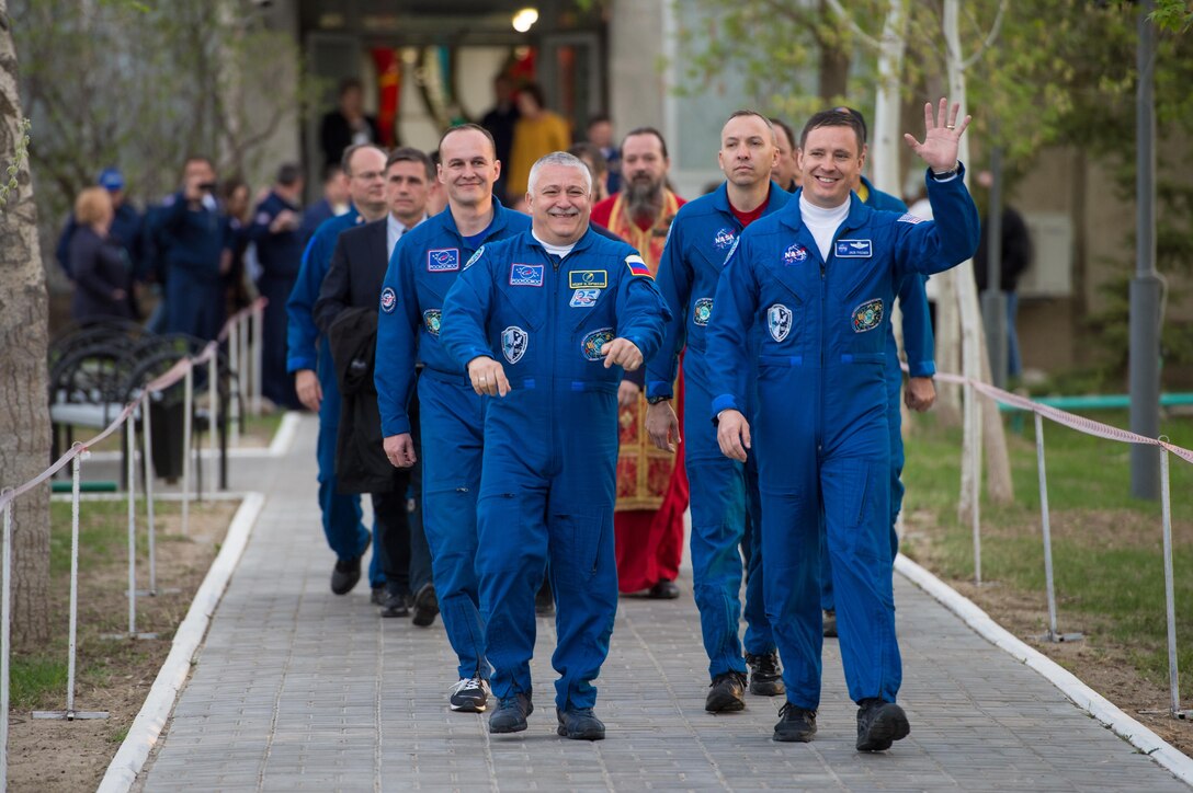 Expedition 51 crew members, Fyodor Yurchikhin, the Soyuz commander of Roscosmos (left) and Col. Jack Fischer, NASA flight engineer (right) wave to family and friends as they depart the Cosmonaut Hotel to suit-up for their Soyuz launch to the International Space Station April 20, 2017, in Baikonur, Kazakhstan. The Soyuz rocket launched at 1:13 p.m. April 20, and sent Yurchikhin and Fischer on a four and a half month mission aboard the International Space Station. (NASA photo/Aubrey Gemignani)