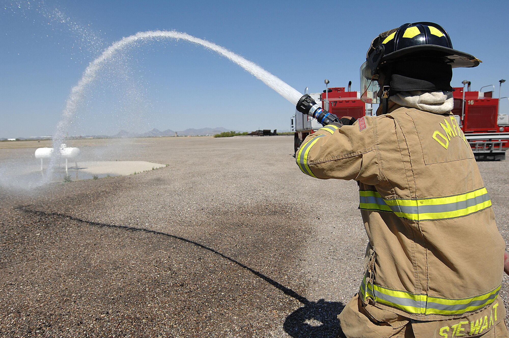 U.S. Air Force Senior Airman Haji Stewart, 355th Civil Engineering Squadron firefighter, participates in a fire attack drill at Davis-Monthan Air Force Base, Ariz., April 19, 2017. D-M firefighters continuously train throughout the week in order to keep their skills honed. (U.S. Air Force photo by Airman 1st Class Frankie Moore)