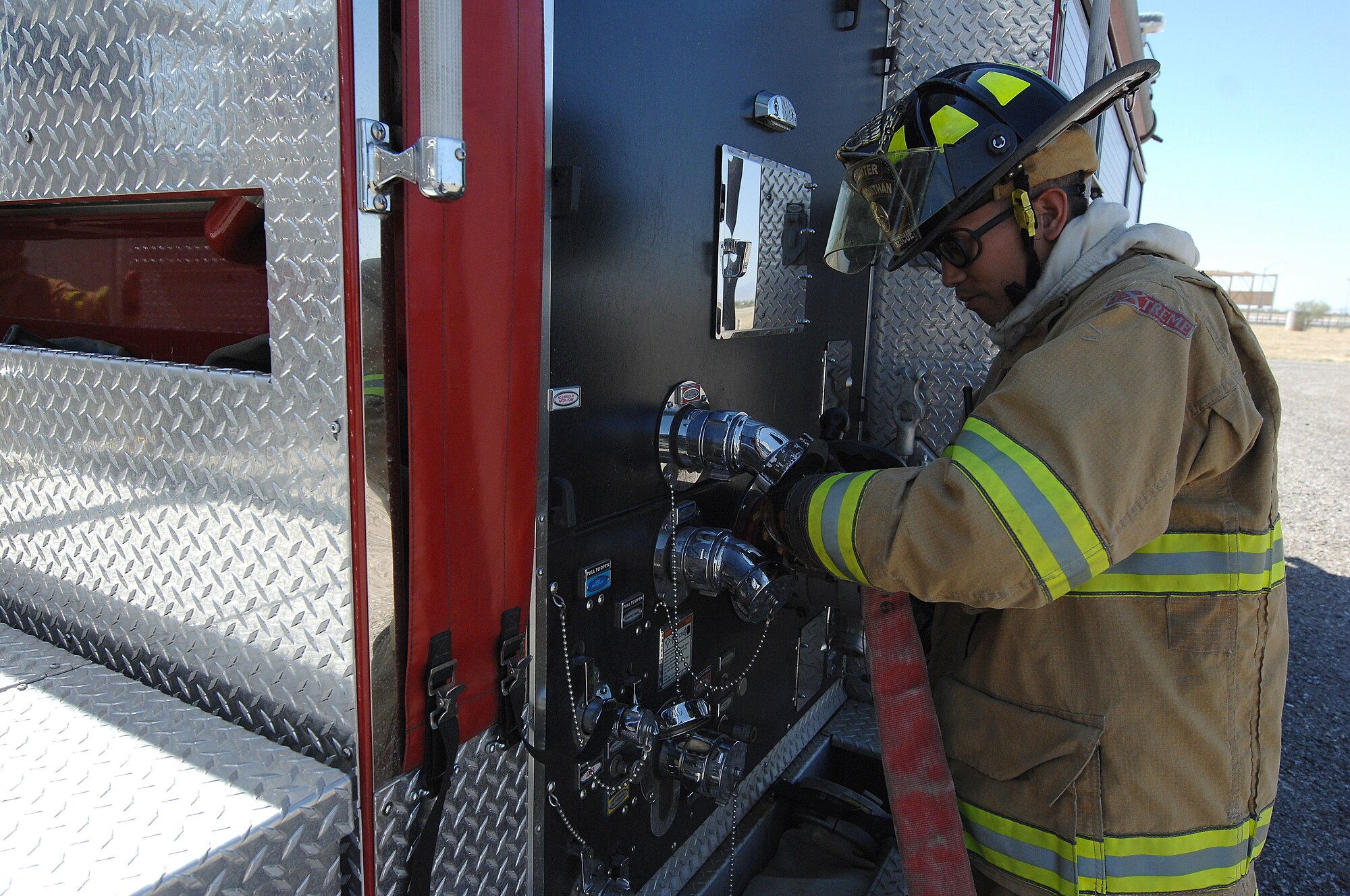 U.S. Air Force Senior Airman Jonathan Bautista, 355th Civil Engineering Squadron firefighter, connects and tightens a fire hose to a fire engine at Davis-Monthan Air Force Base, Ariz., April 19, 2017. D-M has a range of fire engines that can hold between 500 to 3,300 gallons of water. (U.S. Air Force photo by Airman 1st Class Frankie Moore)