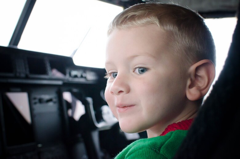 Nathan Heiney, son of Senior Airman Brian Heiney, 403rd Security Forces Squadron and Staff Sgt. Heather Heiney, 403rd Wing Public Affairs, sees a WC-130J Super Hercules aircraft up-close for the first time during the 403rd Wing children's holiday party Dec. 12 at Keesler Air Force Base, Mississippi. (U.S. Air Force photo/Staff Sgt. Heather Heiney)