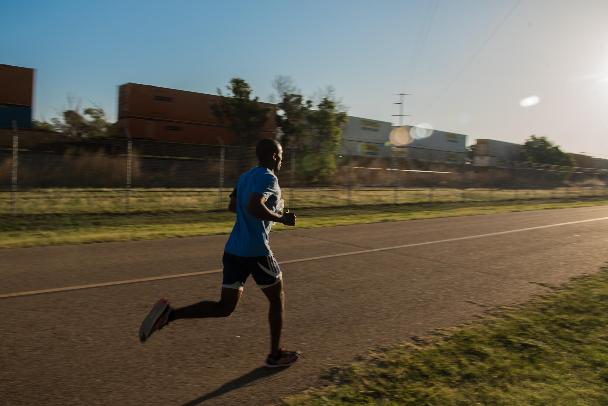 A participant of the Arbor Day and Earth Day 5K fun run jogs along North Perimeter Road on Cannon Air Force Base, NM, April 19, 2017. Along with the fun run, Cannon also had a tree planting ceremony and a recycling center demonstration. (U.S. Air Force photo by Staff Sgt. Michael Washburn/Released)
