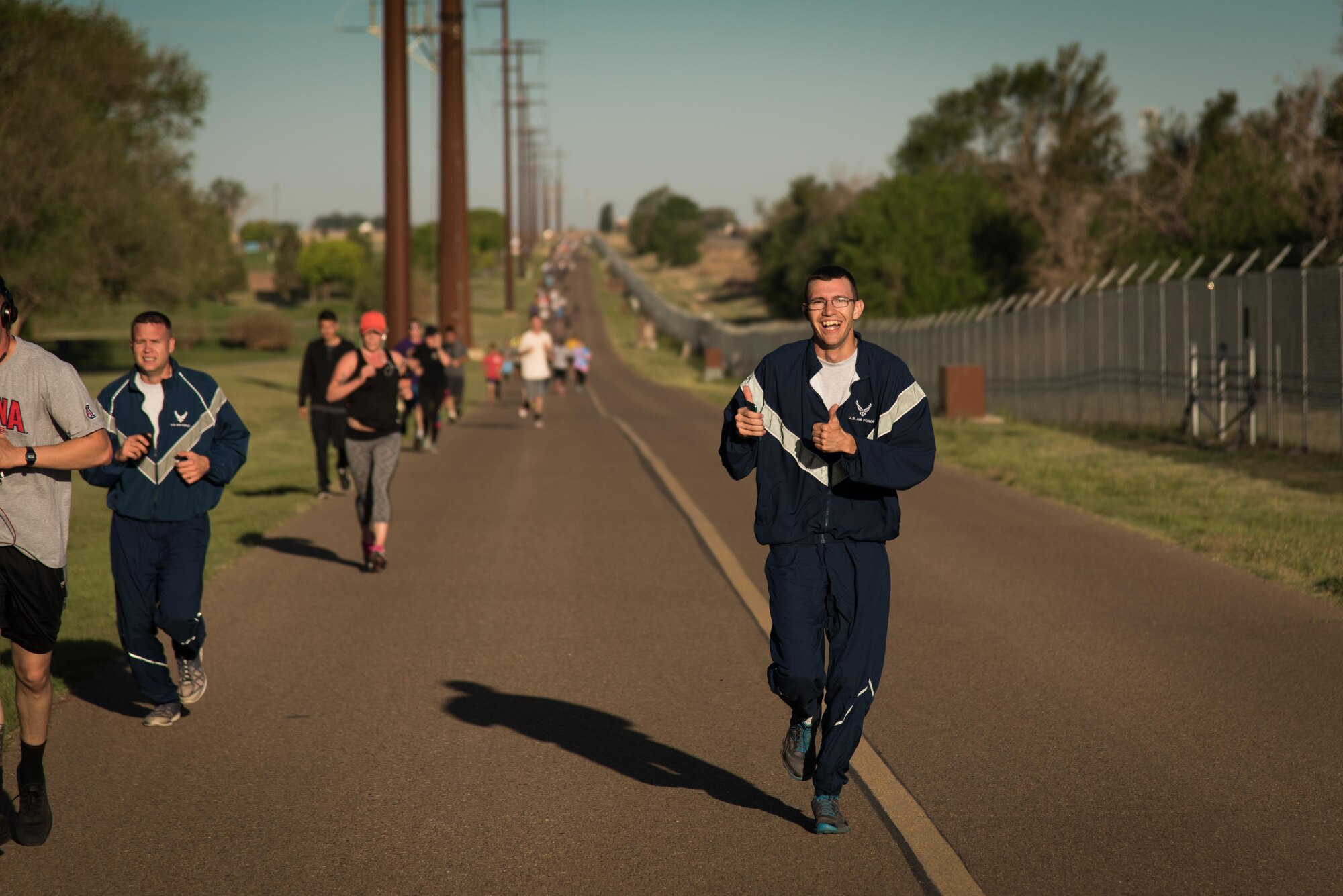 An Airman flashes a thumbs up during the Arbor Day and Earth Day 5K fun run at Unity Park on Cannon Air Force Base, NM, April 19, 2017. Along with the fun run, Cannon also had a tree planting ceremony and a recycling center demonstration. (U.S. Air Force photo by Staff Sgt. Michael Washburn/Released)