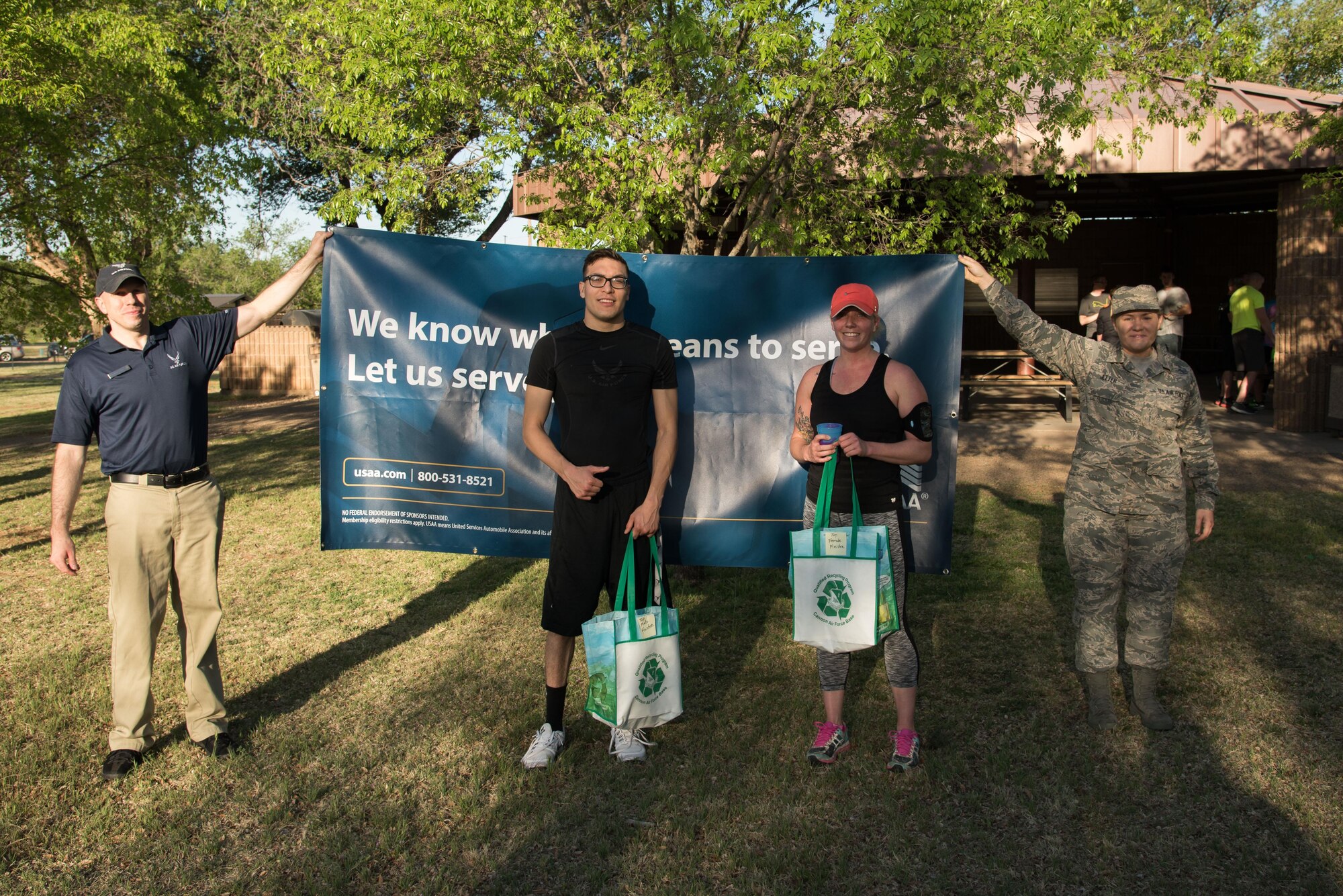 (Middle left) Ilan Serrano, and (middle right) Tayler Wyttenbach, pose for a picture after finishing the Arbor Day and Earth Day 5K fun run as the fastest male and female at Unity Park on Cannon Air Force Base, NM, April 19, 2017. Serrano finished the race in 17:59 and Wyttenbach finished in 23:29. (U.S. Air Force photo by Staff Sgt. Michael Washburn/Released)