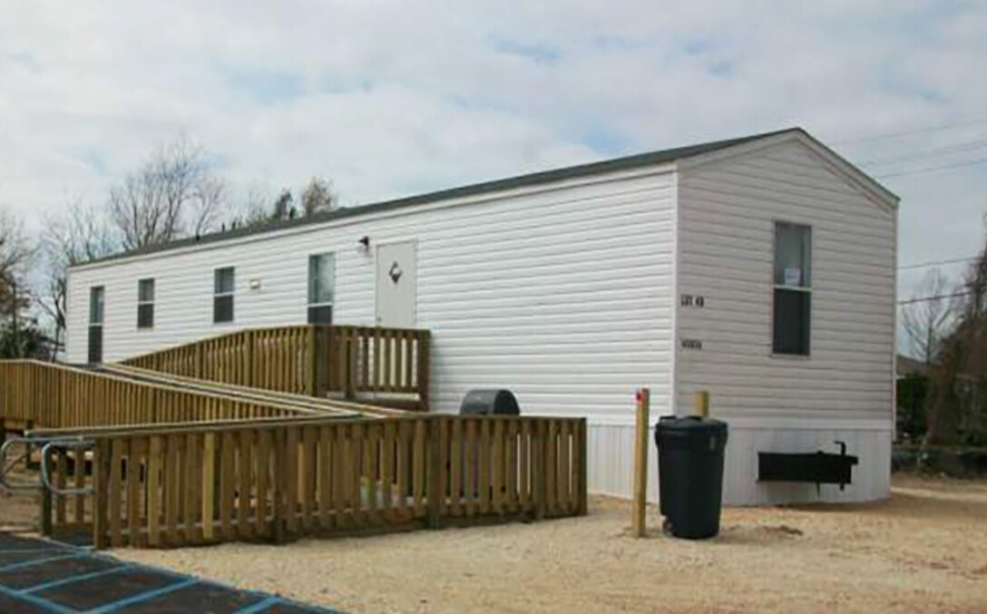A FEMA Manufactured Housing Unit used as temporary quarters for individuals displaced by a natural disaster. The 1-3 room furnished units, complete with utilities, conform to the U.S. Department of Housing and Urban Development standards and FEMA contract requirements. Eligible applicants can reside in such units for up to 18 months after the declaration of a federal disaster. 