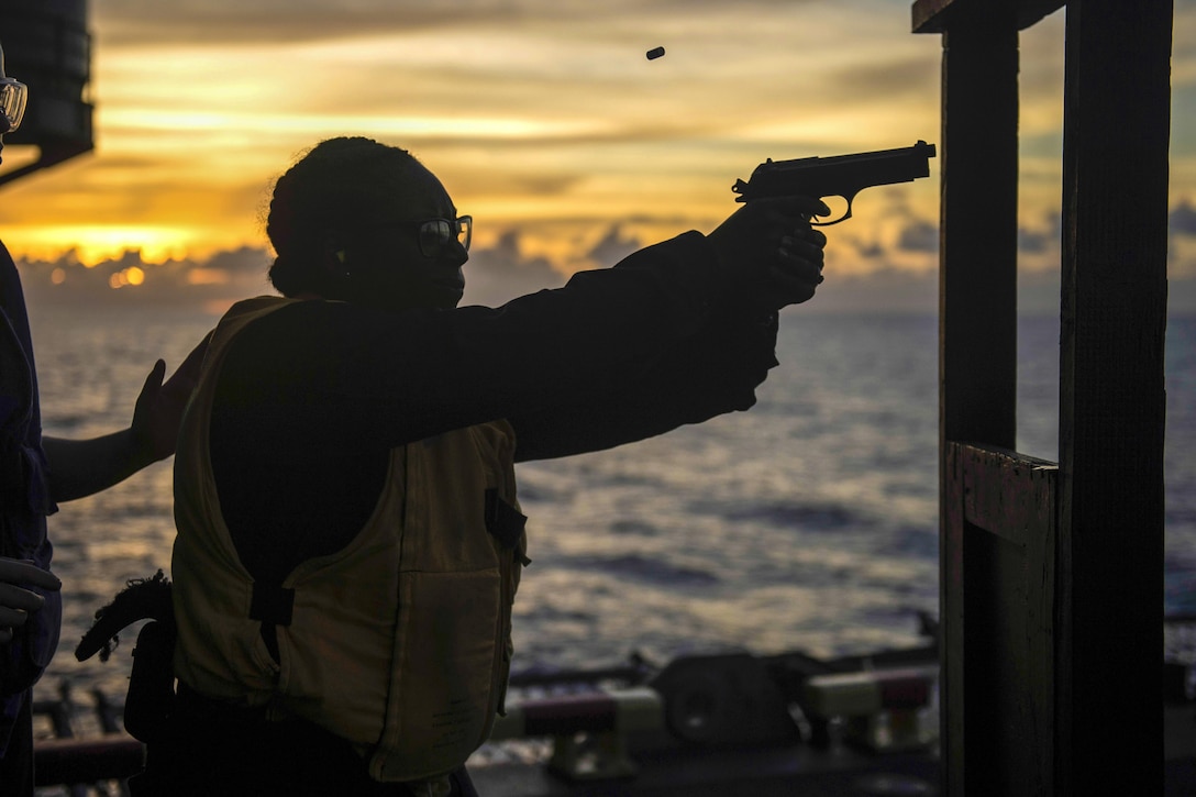 Navy Petty Officer 3rd Class Jalisa Hill fires an M9 pistol during small arms weapons qualifications aboard the amphibious assault ship USS Makin Island in the South China Sea, April 15, 2017. The Makin Island Amphibious Ready Group and the embarked 11th Marine Expeditionary Unit are operating in the Indo-Asia-Pacific region to enhance amphibious capability with regional partners and serve as a ready-response force for any type of contingency. Navy photo by Petty Officer 3rd Class Devin M. Langer