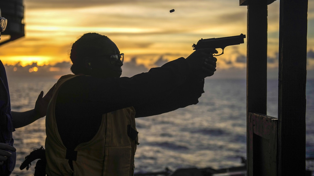 Navy Petty Officer 3rd Class Jalisa Hill fires an M9 pistol during small arms weapons qualifications aboard the amphibious assault ship USS Makin Island in the South China Sea, April 15, 2017. The Makin Island Amphibious Ready Group and the embarked 11th Marine Expeditionary Unit are operating in the Indo-Asia-Pacific region to enhance amphibious capability with regional partners and serve as a ready-response force for any type of contingency. Navy photo by Petty Officer 3rd Class Devin M. Langer