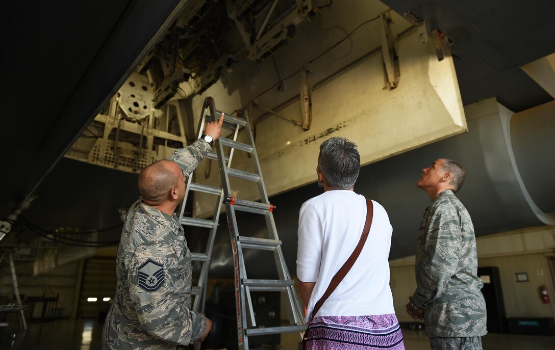 U.S. Air Force Master Sgt. Louis Dewitt, 7th Maintenance Group load standardization team chief, speaks to Maj. Gen. Thomas Bussiere, 8th Air Force commander, and his wife, Barbara, about the loading components inside the bomb bay of a B-1B Lancer at Dyess Air Force Base, Texas, April 18, 2017. While visiting the load barn, the Bussieres met and thanked Airmen who are responsible for loading and securing munitions for the B-1. (U.S. Air Force photo by Airman 1st Class Emily Copeland)