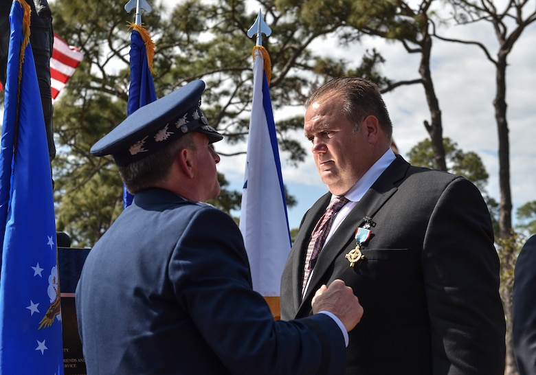 Chief of Staff of the Air Force, Gen. David L. Goldfein, presents Master Sgt. (Ret.) Keary Miller, a retired Special Tactics pararescueman, the Air Force Cross at Hurlburt Field, April 20, 2017. For the first time in Air Force history, two Airmen were simultaneously awarded the service’s highest medal for valorous action in combat. Miller, from the Air National Guard’s 123rd Special Tactics Squadron, and Chris Baradat, a staff sergeant combat controller at the time, both received Silver Star medals for their actions in combat, which were upgraded after a service-wide review. (U.S. Air Force photo by Senior Airman Ryan Conroy) 
