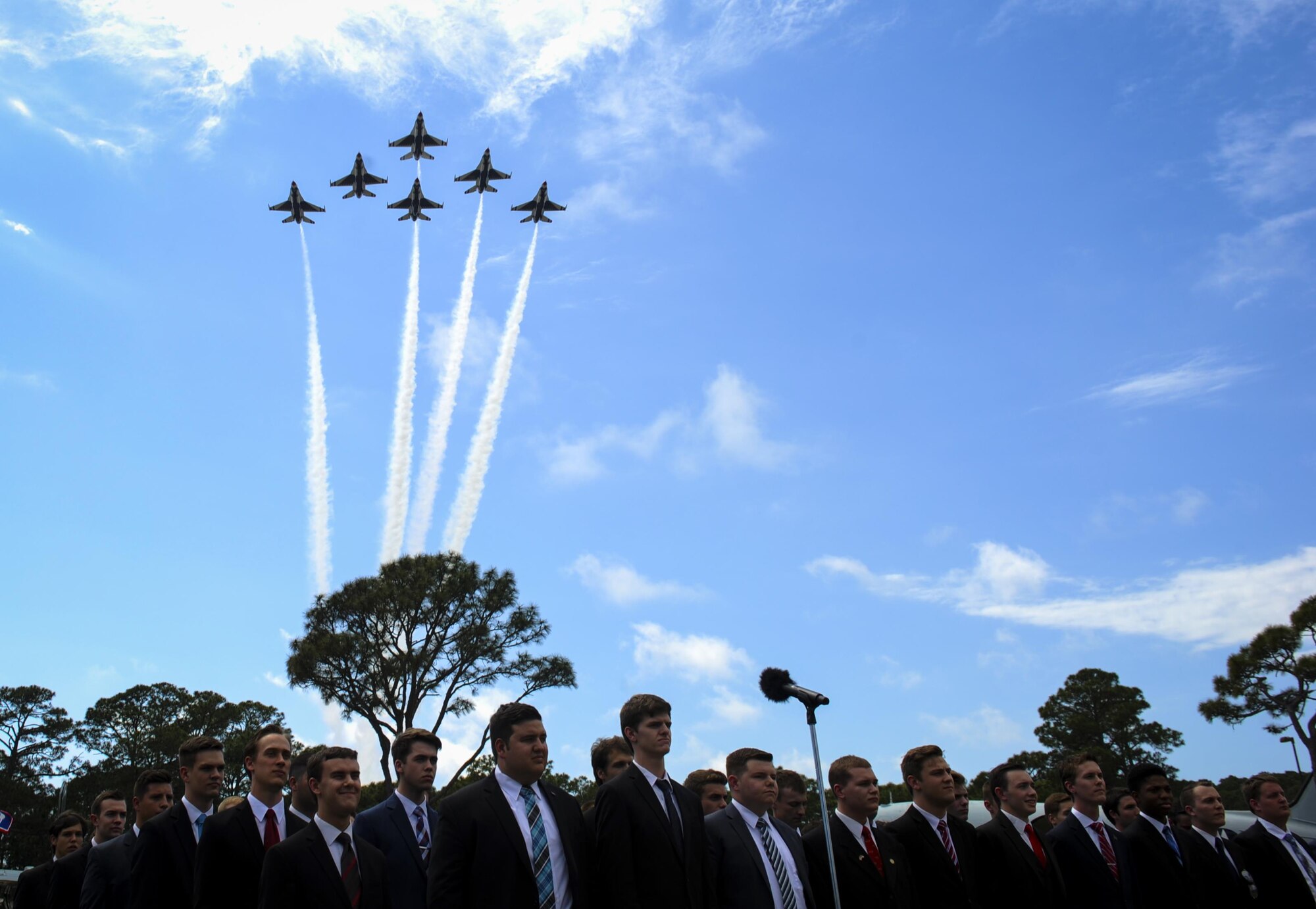 The U.S. Air Force Thunderbirds perform a flyover as the Pensacola Christian College choir sings the National Anthem during a dual Air Force Cross ceremony, April 20, 2017, at Hurlburt Field, Fla. For the first time in Air Force history, two Airmen were simultaneously awarded the service’s highest medal for valorous action in combat. Miller, from the Air National Guard’s 123rd Special Tactics Squadron, and Chris Baradat, a combat controller since separated, both received Silver Star medals for their actions in combat, which were upgraded after a service-wide review. (U.S. Air Force photo by Airman 1st Class Dennis Spain) 