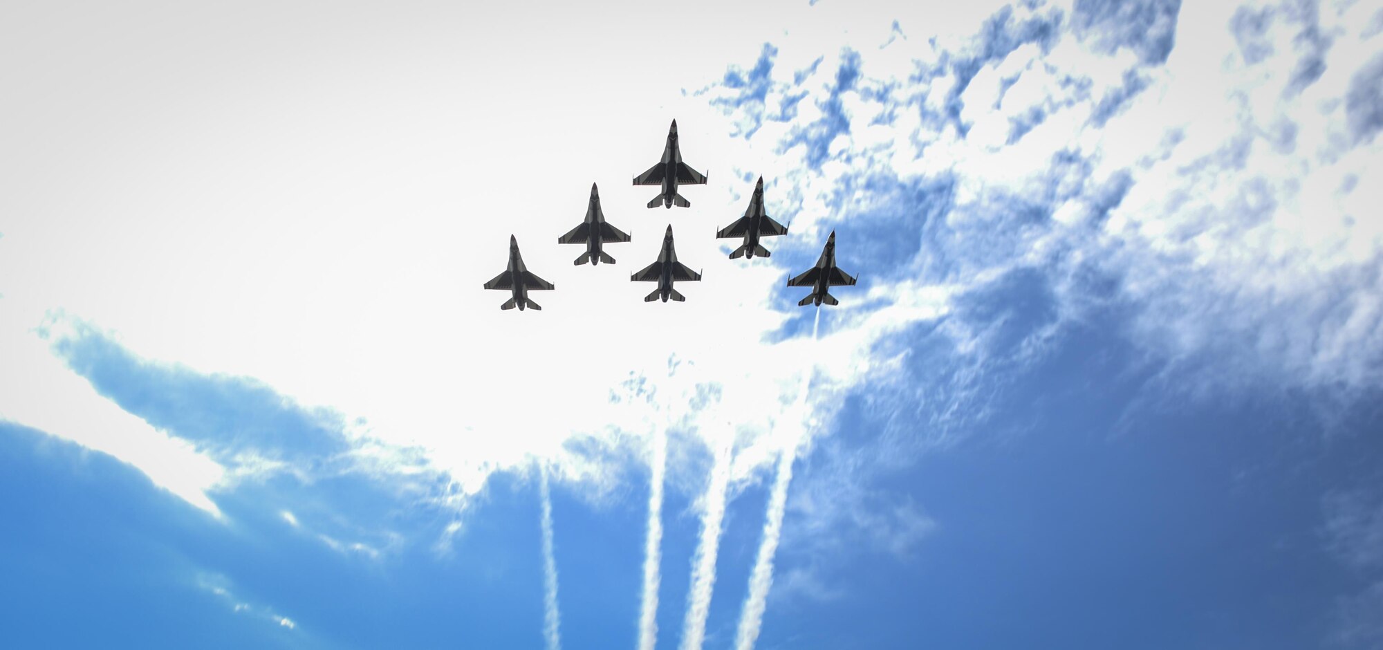 The U.S. Air Force Thunderbirds perform a flyover as the Pensacola Christian College choir sings the National Anthem during a dual Air Force Cross ceremony, April 20, 2017, at Hurlburt Field, Fla. For the first time in Air Force history, two Airmen were simultaneously awarded the service’s highest medal for valorous action in combat. Miller, from the Air National Guard’s 123rd Special Tactics Squadron, and Chris Baradat, a combat controller since separated, both received Silver Star medals for their actions in combat, which were upgraded after a service-wide review. (U.S. Air Force photo by Airman 1st Class Dennis Spain) 