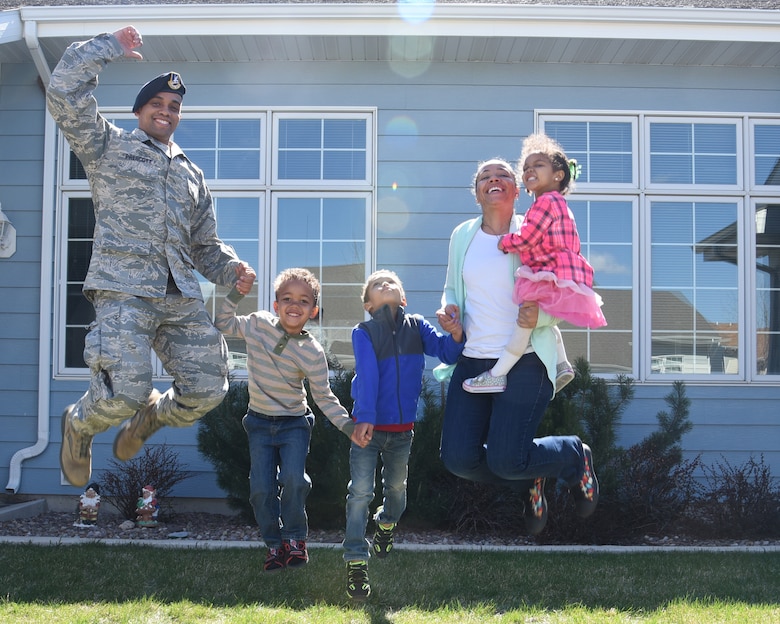 Tech. Sgt. Bennie Prescott, 341st Missile Security Forces Squadron physical security manager, his wife, Ellen and their children jump with excitement April 20, 2017, at Malmstrom Air Force Base, Mont. Bennie and Ellen included their kids on their journey to paying off $253,000 in debt in six years. (U.S. Air Force photo/Senior Airman Jaeda Tookes)