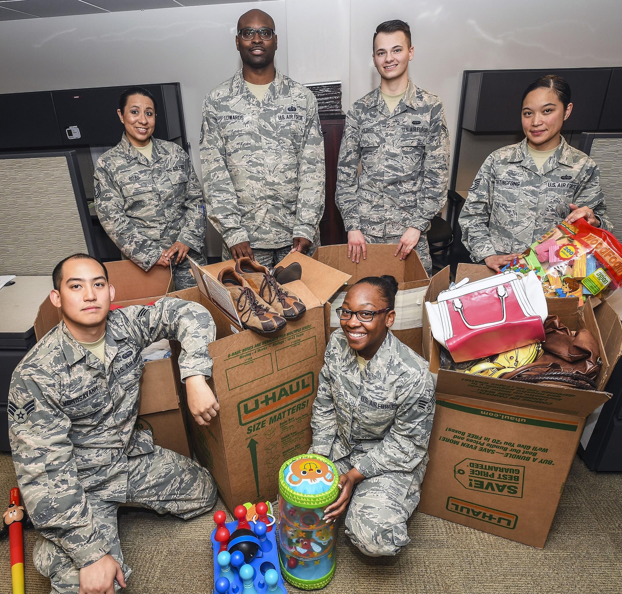 Airmen pose for a photo April 19 at Hill Air Force Base. The Airmen organized a drive to collect cosmetics, clothing, blankets, children’s toys and other items to benefit a local domestic violence shelter. Pictured are: front row, left to right, Senior Airman Matthew Vongsavanh and Senior Airman Taekausha Lomax; back row, left to right, Master Sgt. Vanessa Soto, Tech. Sgt. Gerald Edwards, Airman 1st Class Taylor Holdorf, and Tech. Sgt. Valarie Taitingfong. Not pictured are: Capt. Kristi Newberry, Tech. Sgt. Mary Mines, Senior Airman Fabian Ferretti, Senior Airman Douglas Crisp, Airman 1st Class Ian Padilla and Airman 1st Class Gavin Rucker. (U.S. Air Force photo)