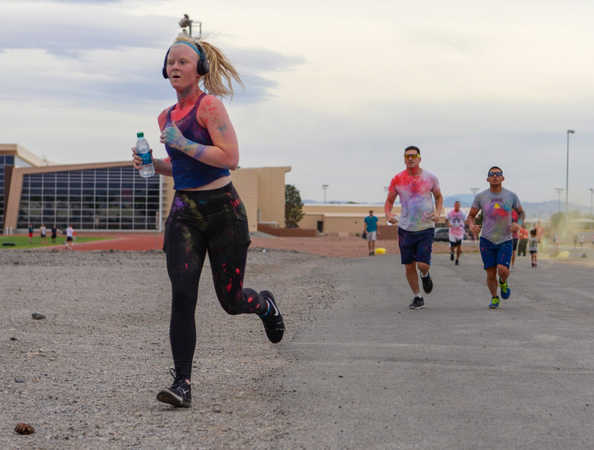 Senior Airman Mikaley Kline, 99th Air Base Wing Public Affairs photojournalist, sprints ahead of other Airmen at the 5k Color Run/Walk, April 7, 2017, at Nellis Air Force Base, Nev. This is the second 5k Color Run/Walk Kline has participated in at Nellis AFB. (U.S. Air Force photo by Airman 1st Class Andrew D. Sarver/ Released)


