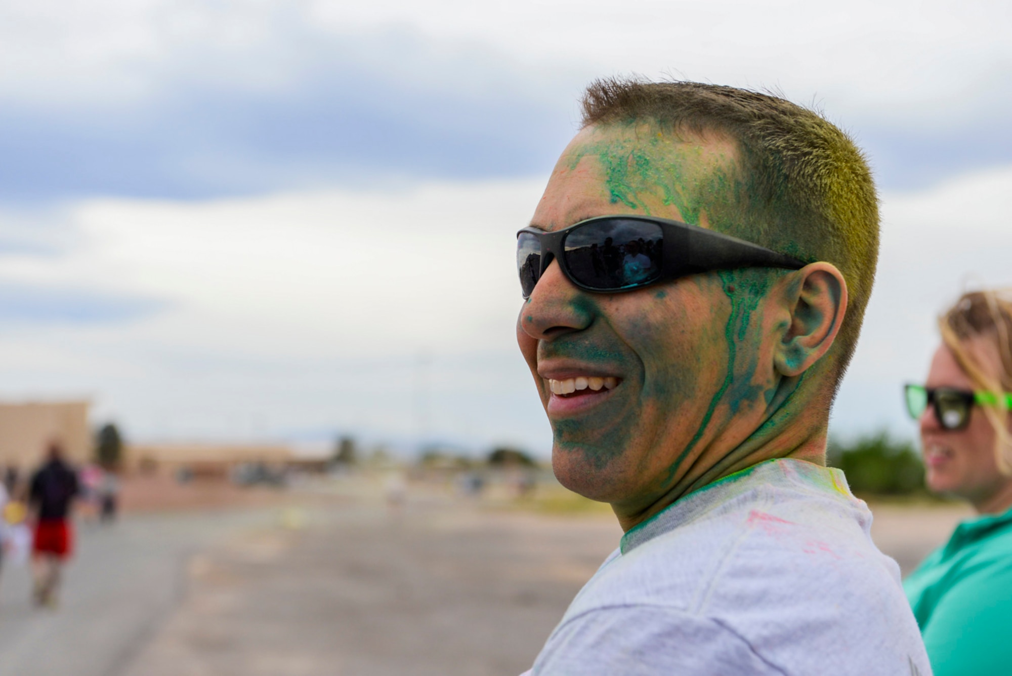 Chief Master Sgt. William Arcuri, 99th Air Base Wing acting command chief, relaxes after finishing the 5k Color Run/Walk, April 7, 2017, at Nellis Air Force Base, Nev. Several base agencies set up stands at the finish line to provide snacks and further information on the services they provide Airmen and their families. (U.S. Air Force photo by Airman 1st Class Andrew D. Sarver/ Released)


