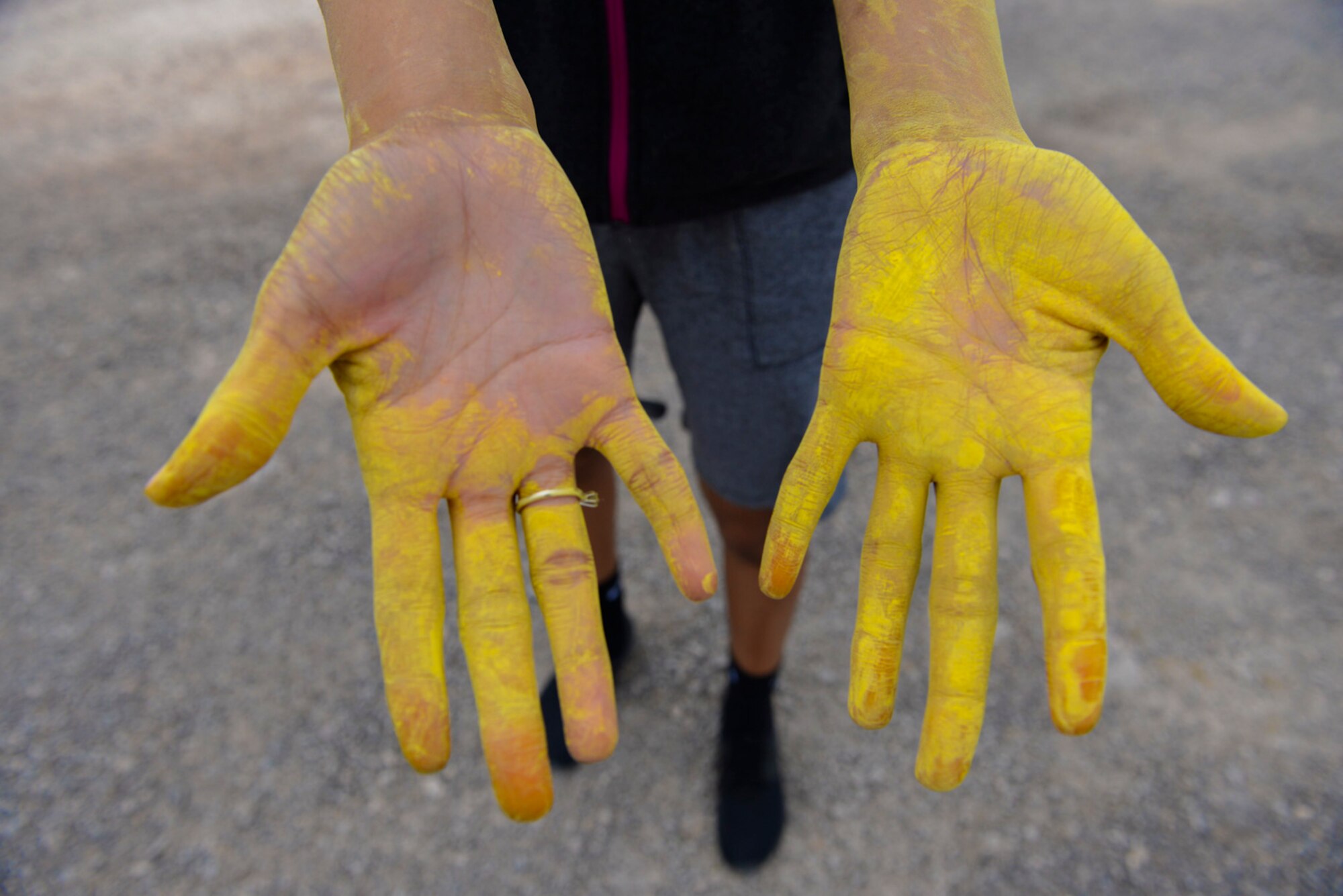 Staff Sgt. Dominique Lindsey, 99th Medical Operations Squadron mental health technician, shows her hands during the 5k Color Run/Walk, April 7, 2017, at Nellis Air Force Base, Nev. The 5k Color Run/Walk raised awareness for Comprehensive Airman Fitness. (U.S. Air Force photo by Airman 1st Class Andrew D. Sarver/ Released)




