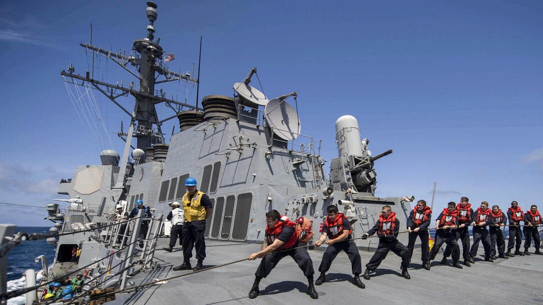 Sailors aboard the USS Shoup heave line during a replenishment at sea in the Pacific Ocean, April 13, 2017. The ship was underway conducting a composite training unit exercise to prepare for a deployment. Navy photo by Petty Officer 3rd Class Maria I. Alvarez