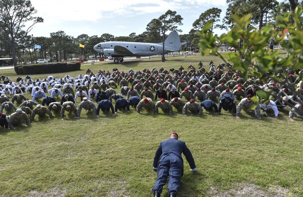 Col. Michael E. Martin, the 24th Special Operations Wing commander, leads Airmen in "Memorial Pushups" honoring the fallen during a dual Air Force Cross ceremony April 20, 2017, at Hurlburt Field, Fla. Two Airmen were simultaneously awarded the service’s highest medal for valorous action in combat. Retired Master Sgt. Keary Miller, from the Air National Guard’s 123rd Special Tactics Squadron, and Chris Baradat, a former combat controller, both received Silver Stars for their actions in combat, which were upgraded after a service-wide review. (U.S. Air Force photo/Senior Airman Ryan Conroy)
