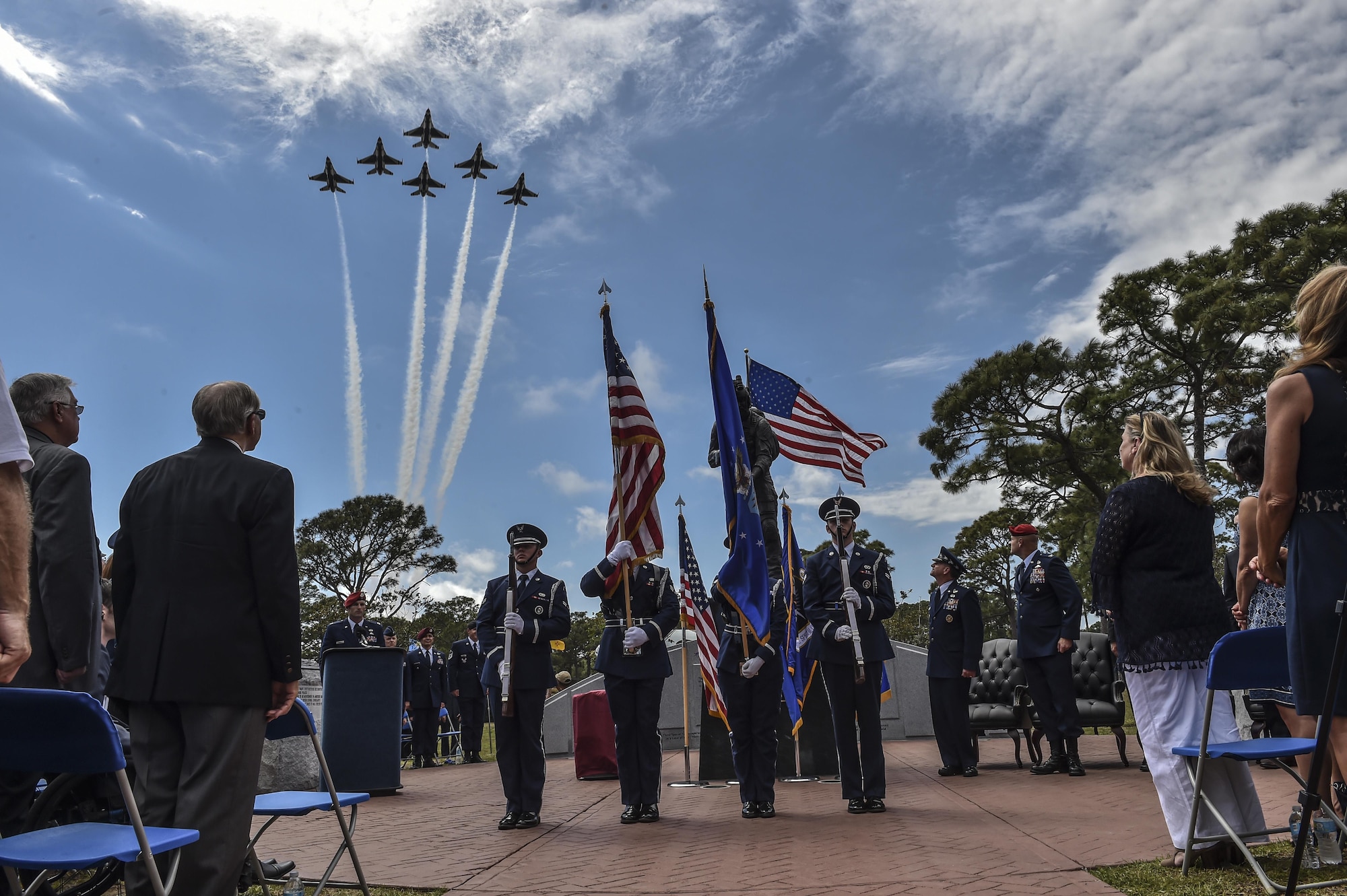 The U.S. Air Force Thunderbirds perform a flyover as the Pensacola Christian College choir sings the National Anthem during a dual Air Force Cross ceremony, April 20, 2017, at Hurlburt Field, Fla. For the first time in Air Force history, two Airmen were simultaneously awarded the service’s highest medal for valorous action in combat. Miller, from the Air National Guard’s 123rd Special Tactics Squadron, and Chris Baradat, a combat controller since separated, both received Silver Star medals for their actions in combat, which were upgraded after a service-wide review. (U.S. Air Force photo by Senior Airman Ryan Conroy) 