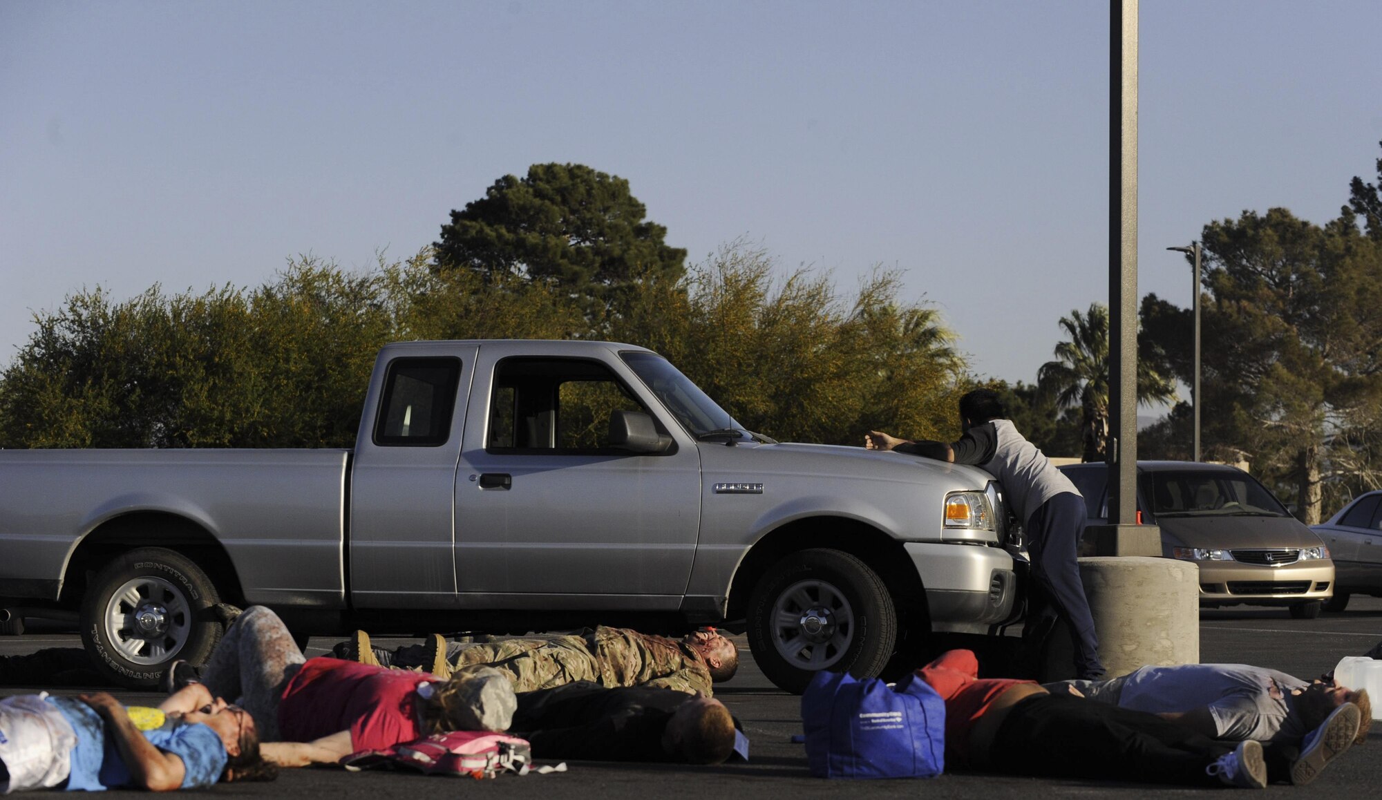 During a simulated attack, victims act out being hit by a truck during the Major Accident Response Exercise at Nellis Air Force Base, Nev., April 13, 2017. The base conducted the exercise to evaluate real-life response capabilities of emergency personnel for scenarios that could impact the base. (U.S. Air Force photo by Senior Airman Kevin Tanenbaum/Released)