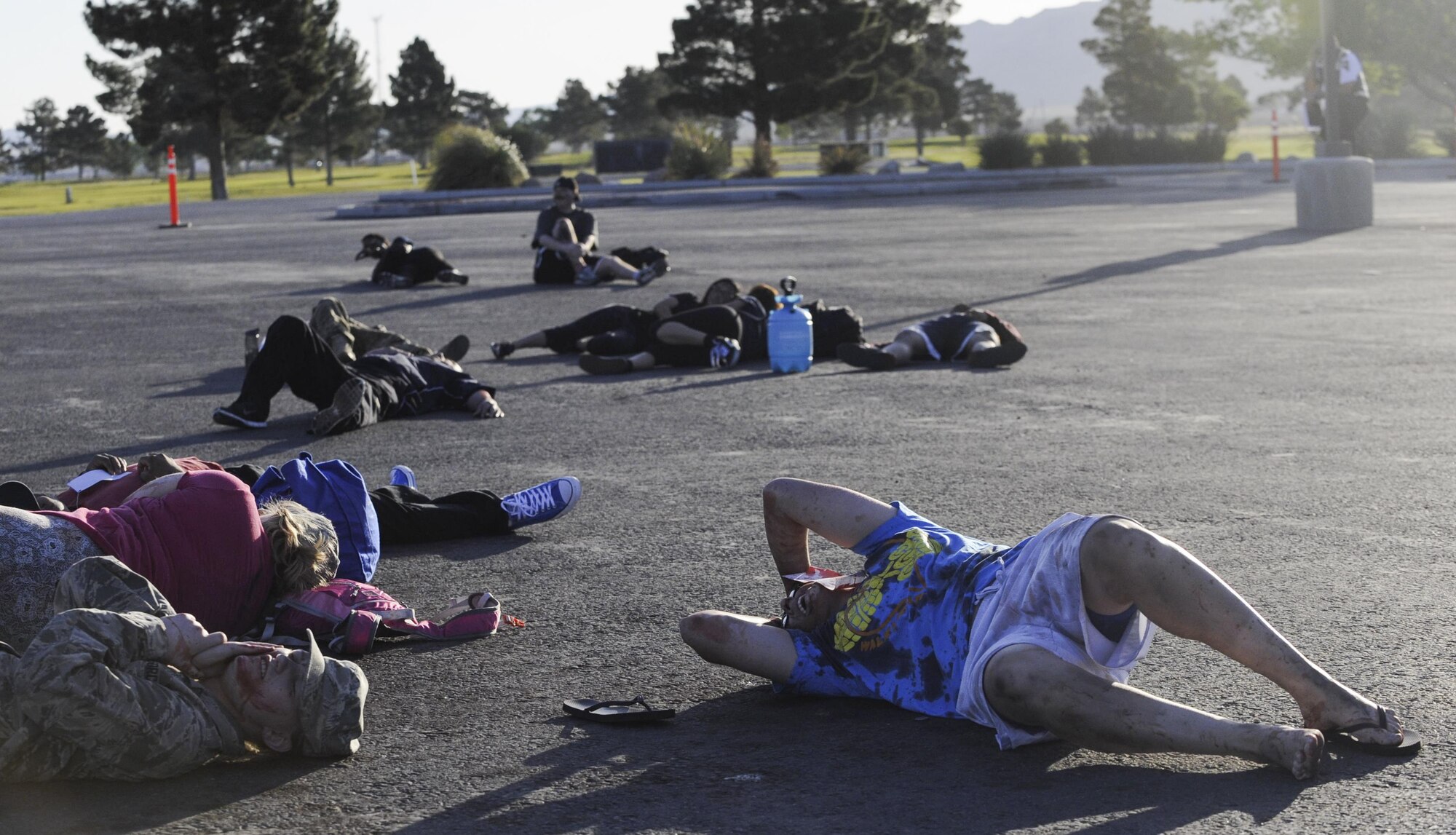 Victims lay on the ground after a simulated attack during the Major Accident Response Exercise at Nellis Air Force Base, Nev., April 13, 2017. The exercise took place to test the participating units ability to respond to an on base emergency. (U.S. Air Force photo by Senior Airman Kevin Tanenbaum/Released)