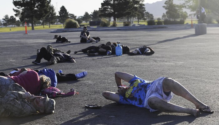 Victims lay on the ground after a simulated attack during the Major Accident Response Exercise at Nellis Air Force Base, Nev., April 13, 2017. The exercise took place to test the participating units ability to respond to an on base emergency. (U.S. Air Force photo by Senior Airman Kevin Tanenbaum/Released)