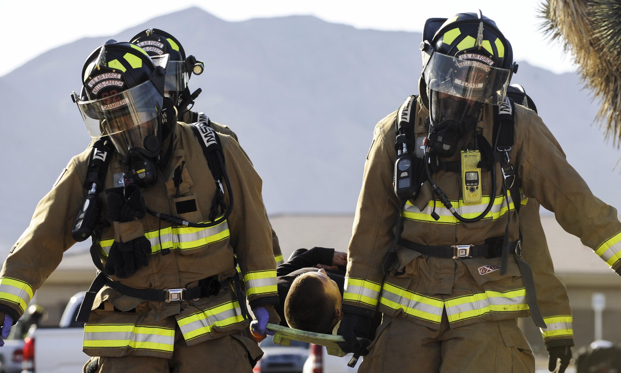 Firefighters from the 99th Civil Engineer Squadron carry a simulated victim on a stretcher during the Major Accident Response Exercise at Nellis Air Force Base, Nev., April 13, 2017. The MARE tested first responders’ skills in a controlled environment to give them confidence in handling any world situation. (U.S. Air Force photo by Senior Airman Kevin Tanenbaum/Released)