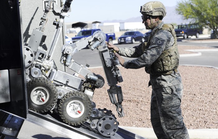 An explosive ordinance disposal technician from the 99th Civil Engineer Squadron prepares a bomb disposal robot during the Major Accident Response Exercise at Nellis Air Force Base, Nev., April 13, 2017. The MARE provides valuable training for many squadrons at Nellis AFB.  (U.S. Air Force photo by Senior Airman Kevin Tanenbaum/Released)