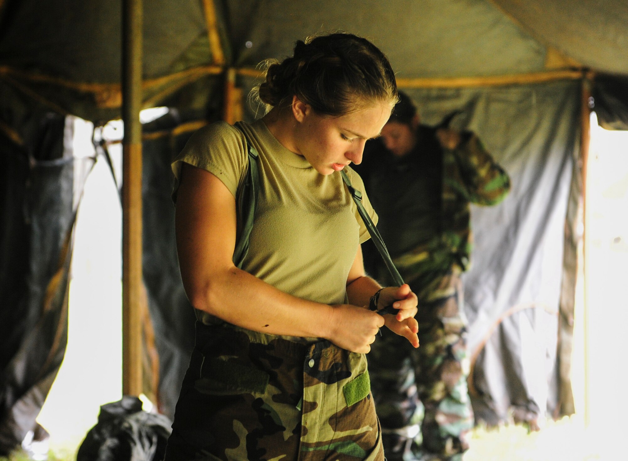 Senior Airman Katelyn Ramsey, 535th Airlift Squadron aviation resource manager, dons her Mission Oriented Protective Posture (MOPP) gear for an exercise scenario during Exercise TROPIC THUNDER 2017 (XTT17), at Wheeler Army Airfield, Hawaii, April 20, 2017.  XTT17 is a two part full spectrum readiness exercise hosted by the 15th Wing to test the individual, organizational and expeditionary readiness of the Airmen stationed at Joint Base Pearl Harbor-Hickam. (U.S. Air Force photo by Tech. Sgt. Heather Redman)