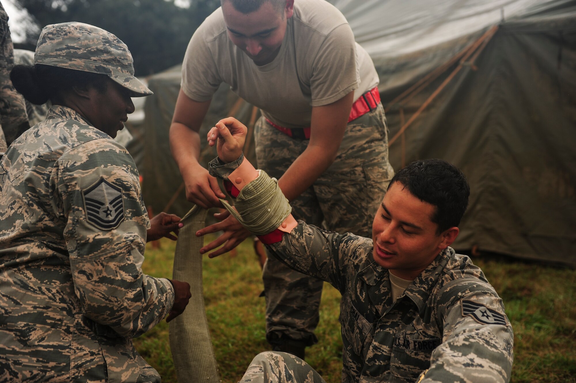 Airmen stationed at Hickam Field simulate self-aid buddy care on each other during Exercise TROPIC THUNDER 2017 (XTT17), at Wheeler Army Airfield, Hawaii, April 20, 2017.  XTT17 is a two part full spectrum readiness exercise hosted by the 15th Wing to test the individual, organizational and expeditionary readiness of the Airmen stationed at Joint Base Pearl Harbor-Hickam. (U.S. Air Force photo by Tech. Sgt. Heather Redman)