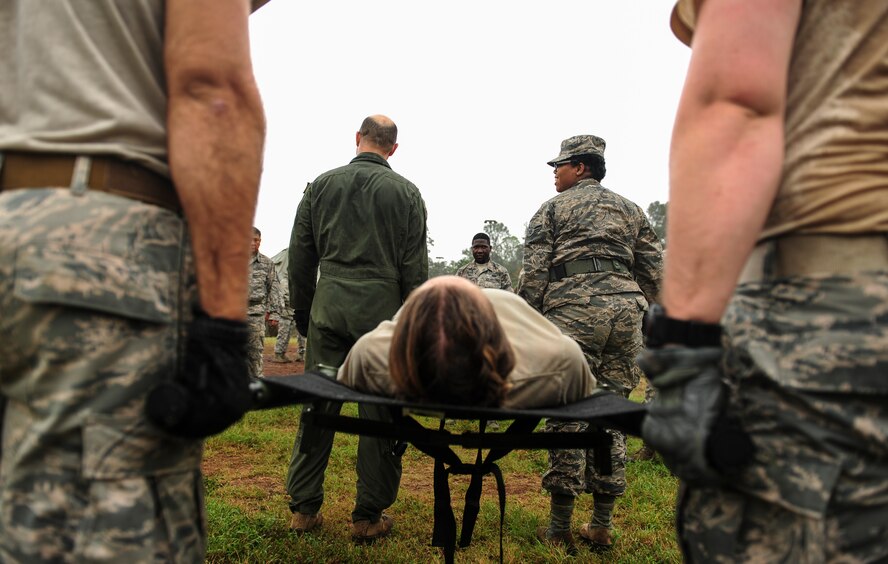 Airmen from across Hickam Field practice litter carries during the hands on self-aid buddy care lessons for Exercise TROPIC THUNDER 2017 (XTT17), at Wheeler Army Airfield, Hawaii, April 20, 2017.  XTT17 is a two part full spectrum readiness exercise hosted by the 15th Wing to test the individual, organizational and expeditionary readiness of the Airmen stationed at Joint Base Pearl Harbor-Hickam. (U.S. Air Force photo by Tech. Sgt. Heather Redman)