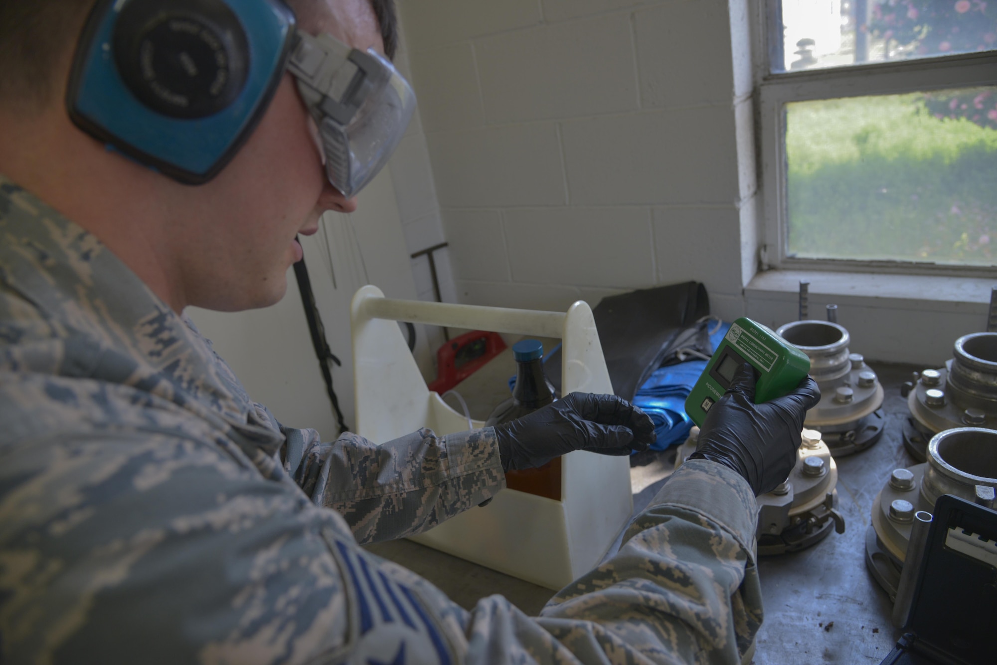 Staff Sgt. David Carson, 374th Logistics Readiness Squadron fuels laboratory NCO in charge, tests the conductivity of JP8 fuel at Yokota Air Base, Japan, April 19, 2017. The lab ensures the fuel is clean, isn’t mixed with other types of fuel and meets the standards the military puts out. (U.S. Air Force photo by Staff Sgt. David Owsianka)